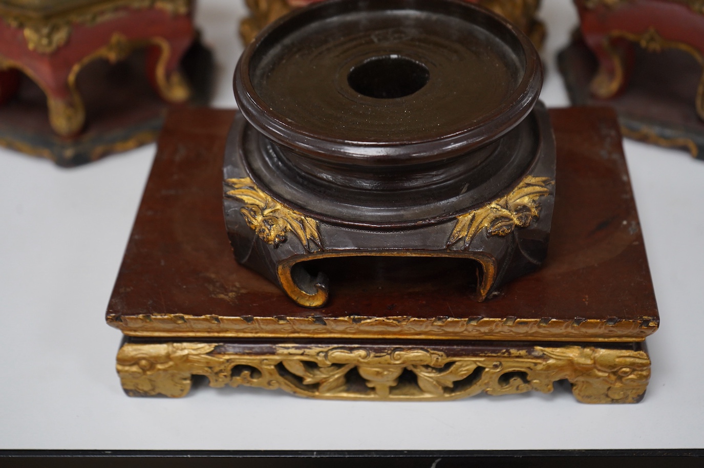 Five Chinese lacquered and partially gilt stands including a hexagonal pair, largest 15cm high. Condition - mostly fair